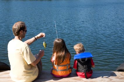 father fishing with 2 children